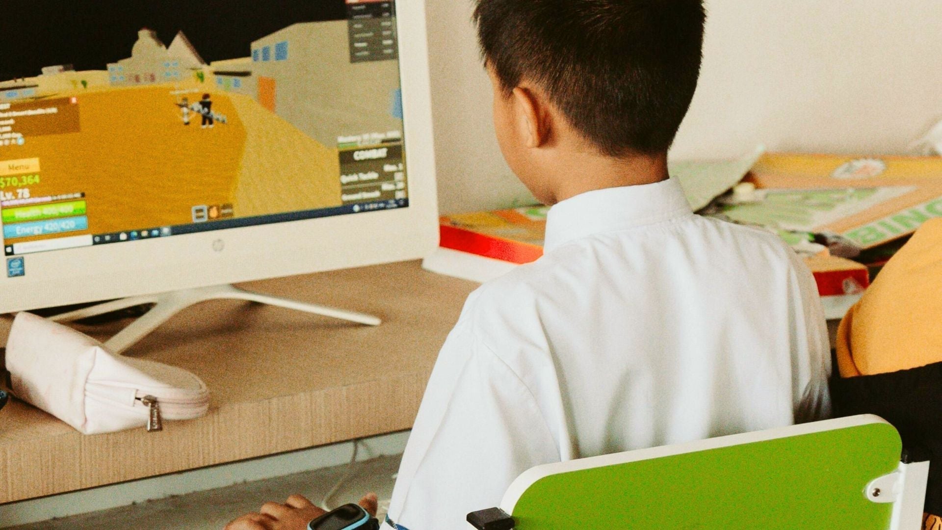 Boy playing Roblox on a computer
