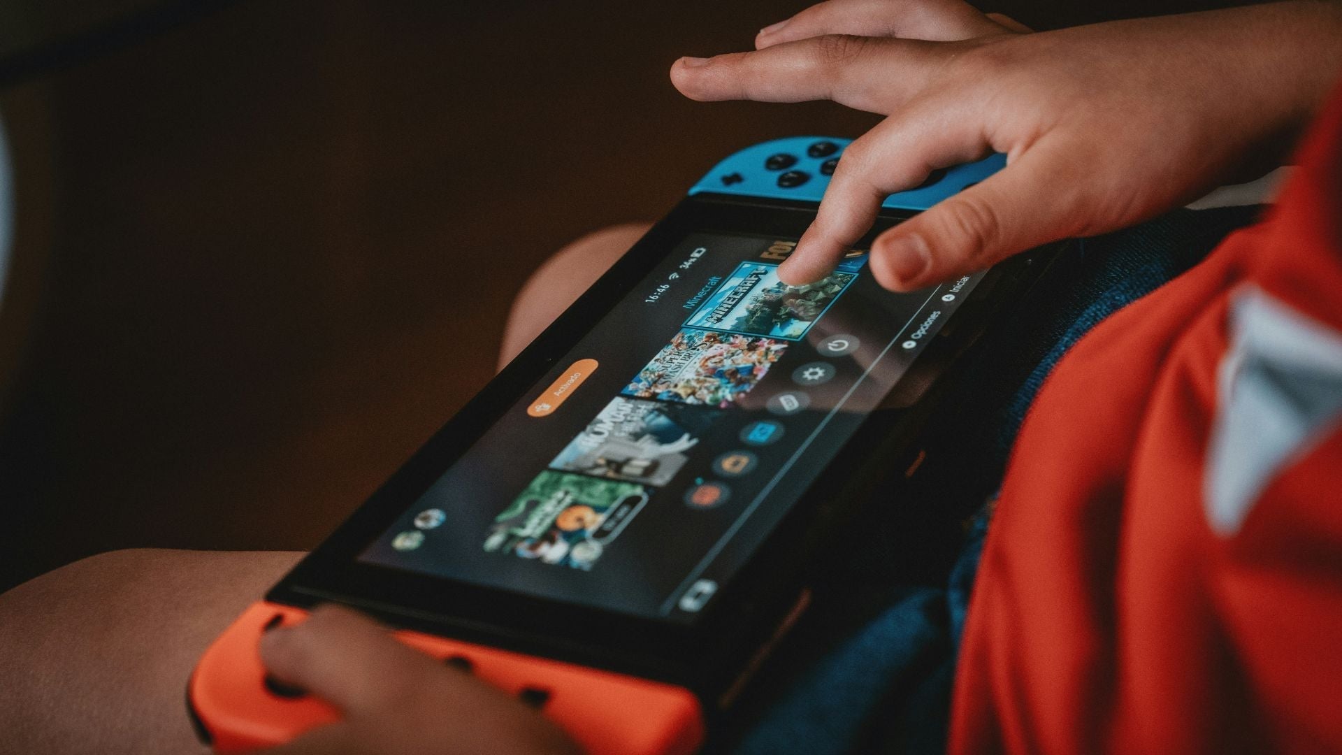 Little boy choosing the Minecraft video game on his Switch console