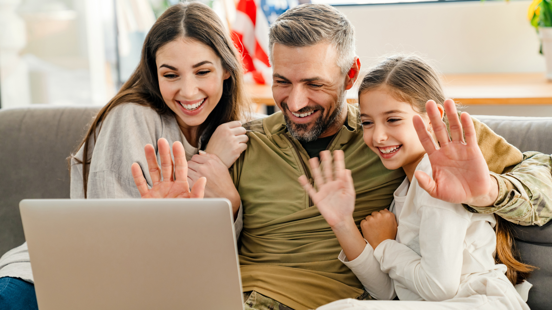 Family doing a videocall with a military family member, smiling and updating on life even miles away