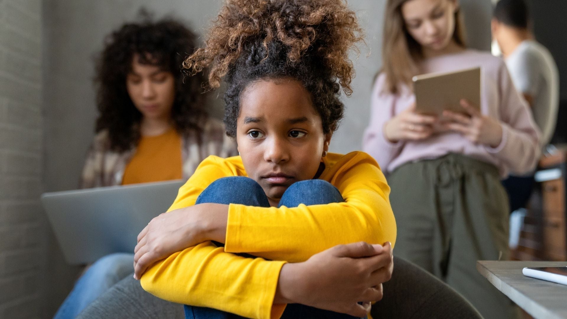 Girl feeling sad because she was excluded from her friends' group chat online