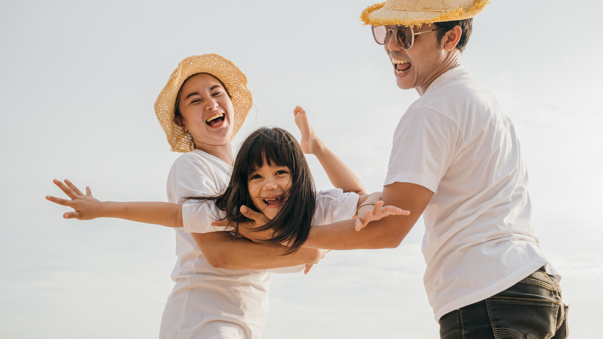 A happy family playing outside, child laughing 
