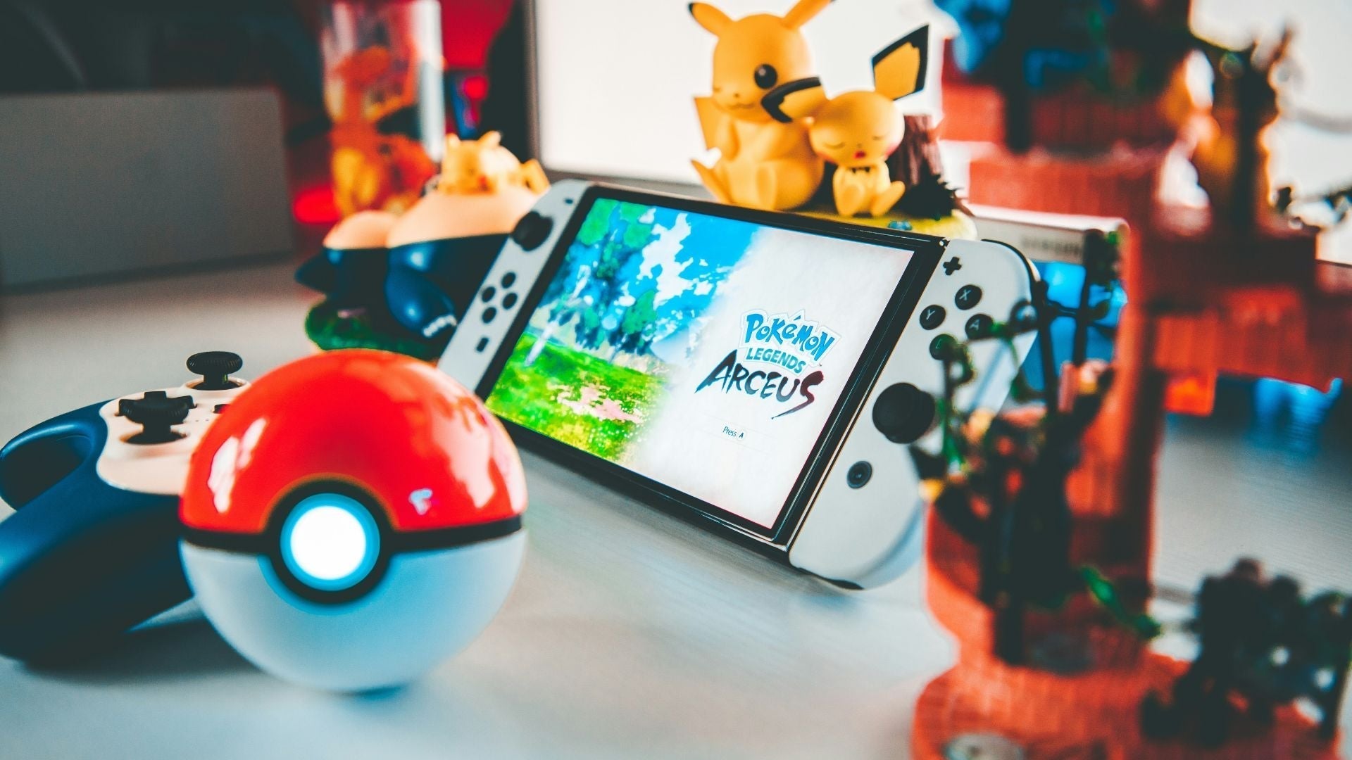 Pokemon game on switch with objects and figurines from the Pokemon universe