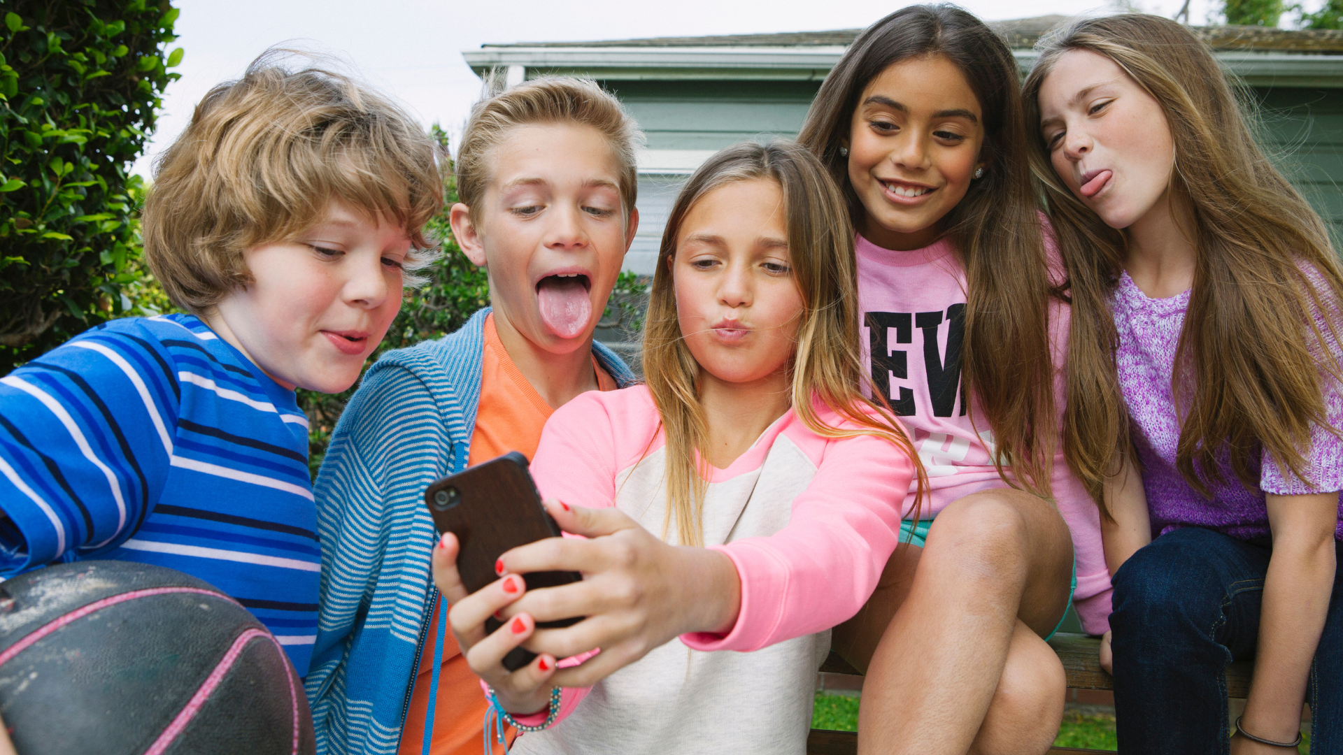 Kids taking a selfie to upload on social media 